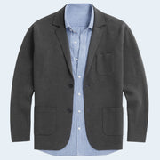 Gray blazer over a blue striped shirt on a light gray background