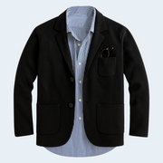 Black blazer over a blue striped shirt on a light gray background