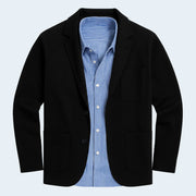 Black blazer with a blue striped shirt on a light gray background